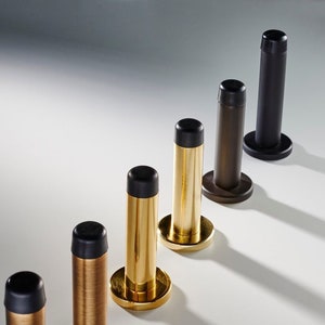 Cylinder brass Door Stop ,un sprung or our new sprung design so you can clean under it . wall mounted . easy install , concealed fixtures