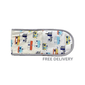 May include: A white oven mitt with a grey trim features a repeating pattern of colourful vintage camper vans. The text "FREE DELIVERY" is printed below the mitt.