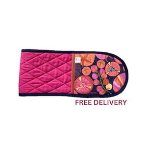 May include: A pink and blue quilted oven mitt with a floral pattern. The mitt is quilted on one side and has a floral print on the other side. FREE DELIVERY.