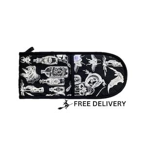 May include: Black oven mitt with a white design featuring bottles, insects, and a skull. The text "FREE DELIVERY" is printed on the bottom of the image.