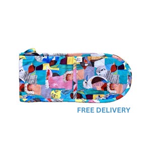 May include: A colourful oven mitt with a pattern of birds and geometric shapes. The mitt is quilted and has a teal blue background.