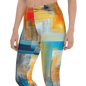 May include: Abstract art leggings with a colorful design featuring shades of blue, yellow, orange, and white. The leggings are made of a stretchy, comfortable fabric and are perfect for yoga, running, or any other workout.