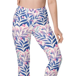 May include: White leggings with a floral pattern in shades of pink and blue. The pattern features leaves and small flowers.