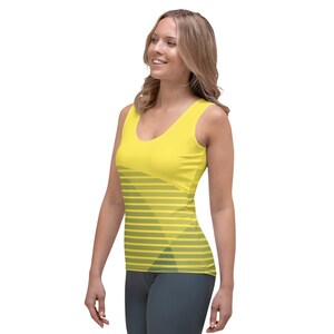 May include: A yellow tank top with a gray and yellow geometric pattern. The tank top has a scoop neck and a sleeveless design.