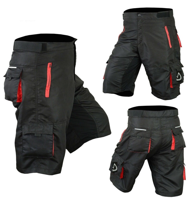 May include: Black cycling shorts with red accents and multiple pockets. The shorts have a zippered pocket on the side and a large cargo pocket on the leg.