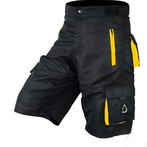 May include: Black cargo shorts with yellow accents and a zippered pocket. The shorts have multiple pockets and a logo on the right leg.