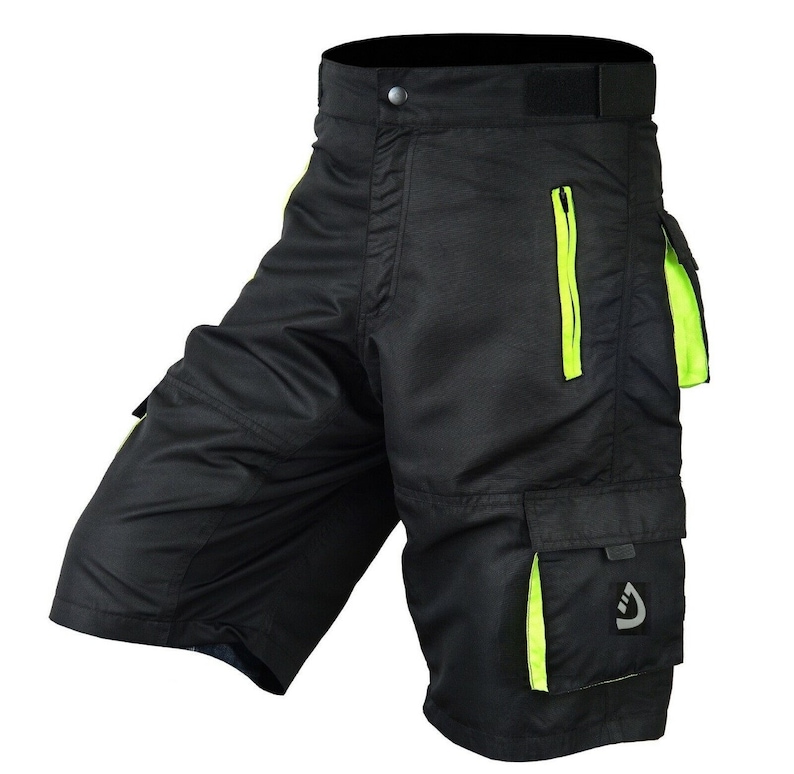 May include: Black cargo shorts with neon green accents and a zippered pocket. The shorts have multiple pockets and a button closure.