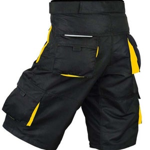 May include: Black work shorts with yellow trim and multiple pockets. The shorts have a belt loop and a zipper fly.