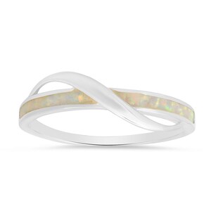 May include: A silver ring with a white opal inlay in a twisted infinity design.
