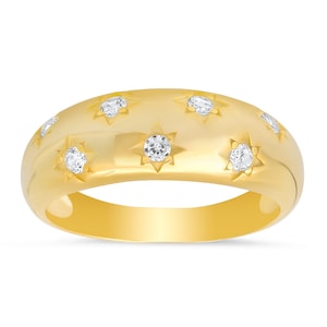 May include: A gold band ring with a smooth, rounded surface and six small diamonds set in star-shaped designs.