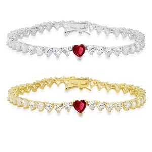 May include: A gold and silver tennis bracelet with a heart-shaped red gemstone in the center. The bracelet is made of small heart-shaped stones.