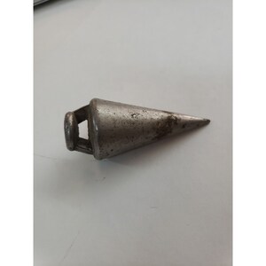 May include: A silver metal plumb bob with a pointed tip and a loop at the top.