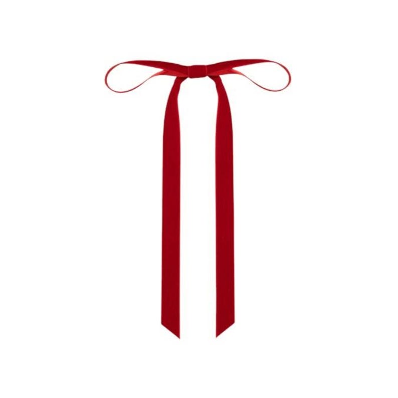 a velvet hair bow made with thin velvet ribbon in a long tail design attached to a french barrette clip, shown as a long tail hair bow suitable as a hair bow for women and hair bows for girls. the shape works as a ribbon hair bow or hairpin bow clip, styled like a ponytail holder bow or long ribbon bow. ideal as a christmas hair bow and fits gifting needs such as gift for her or gift for girl.