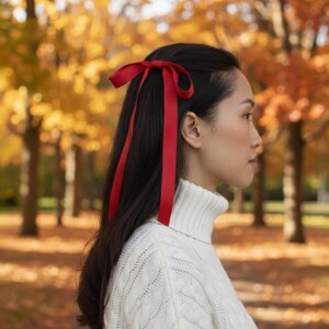 a velvet hair bow made with thin velvet ribbon in a long tail design attached to a french barrette clip, shown as a long tail hair bow suitable as a hair bow for women and hair bows for girls. the shape works as a ribbon hair bow or hairpin bow clip, styled like a ponytail holder bow or long ribbon bow. ideal as a christmas hair bow and fits gifting needs such as gift for her or gift for girl.