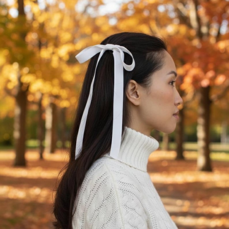 a velvet hair bow made with thin velvet ribbon in a long tail design attached to a french barrette clip, shown as a long tail hair bow suitable as a hair bow for women and hair bows for girls. the shape works as a ribbon hair bow or hairpin bow clip, styled like a ponytail holder bow or long ribbon bow. ideal as a christmas hair bow and fits gifting needs such as gift for her or gift for girl.