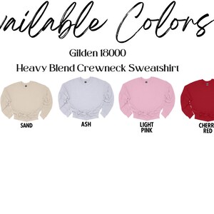 May include: Image showcasing a selection of Gildan 18000 Heavy Blend Crewneck Sweatshirts in various colors. Colors include white, black, sand, ash, light pink, cherry red, and forest green. The text "Available Colors" is at the top.