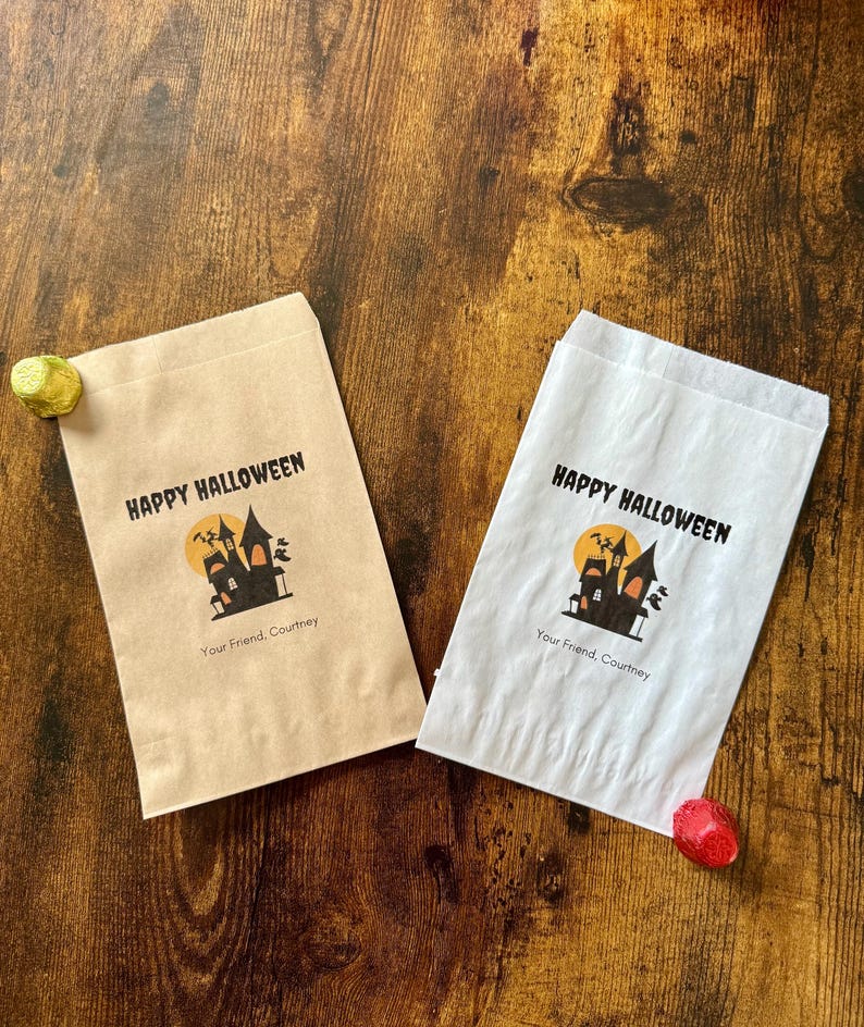 May include: Two Halloween-themed gift bags, one tan and one white, with a spooky castle design and the words "Happy Halloween." The bags also include the text "Your Friend, Courtney."