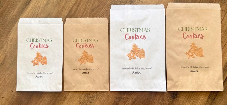 May include: Four rectangular paper bags in white and brown, featuring the printed text CHRISTMAS Cookies and From the Holiday kitchen of Jessica, accompanied by a graphic illustration of three assorted holiday-themed cookies.