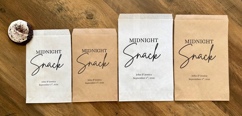 May include: Four rectangular paper bags in white and kraft brown colors, each printed with the text MIDNIGHT Snack, John & Jessica, and September 8th, 2026. A single round cookie with white frosting and dark sprinkles sits to the left of the bags.