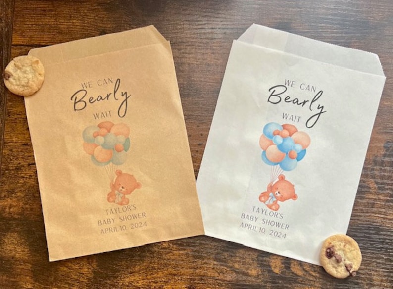 May include: Two paper treat bags, one tan and one white, with a baby shower theme. Each bag features a teddy bear holding balloons and the text "We Can Bearly Wait." The date "April 10, 2024" is also printed.