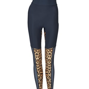 May include: Black leggings with a leopard print mesh panel on the lower legs.