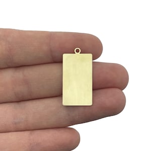 May include: Gold-toned metal rectangular tag with a loop at the top. The tag is blank and ready for personalization.