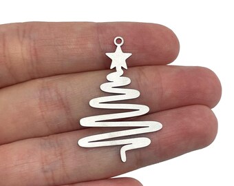 May include: Silver metal charm shaped like a Christmas tree with a star on top. The tree is made of a wavy line design.