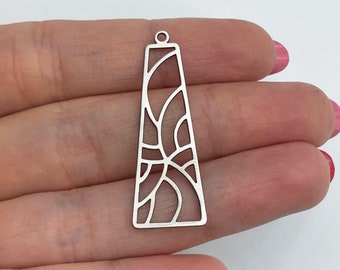 May include: Silver pendant featuring a geometric design. The pendant is shaped like a long, thin rectangle with a loop at the top for hanging.