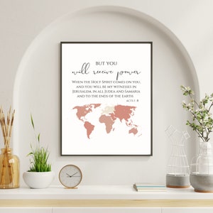 May include: A printable wall art design with a pink and white world map and a quote from the Bible: "But you will receive power when the Holy Spirit comes on you, and you will be my witnesses in Jerusalem, in all Judea and Samaria, and to the ends of the earth." Acts 1:8