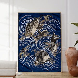May include: A blue and gold abstract print featuring three black and white fish swimming in stylized waves. The print is framed in a thin gold frame.