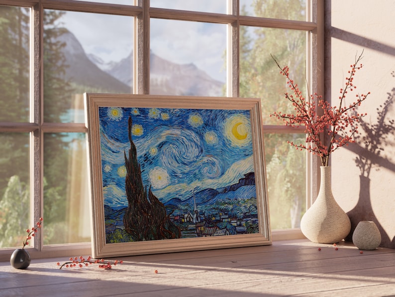 May include: A framed print of Vincent van Gogh's "Starry Night" painting, featuring a swirling blue sky with white stars and a crescent moon. The print is displayed on a wooden table with a vase of red berries and a small decorative object.