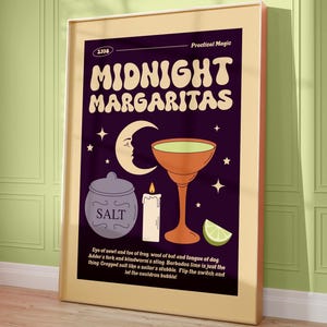 May include: A framed poster with a retro design featuring the words "MIDNIGHT MARGARITAS" in large, stylized letters. The image includes a cocktail glass, moon, stars, salt jar, candle, and lime wedge. The poster has a purple background and a beige frame.