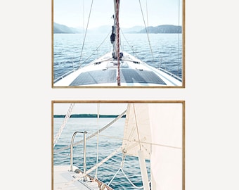 May include: Two photos of a sailboat on the water. The first photo shows the front of the boat with the sail down and the water in the background. The second photo shows the side of the boat with the sail up and the water in the background.