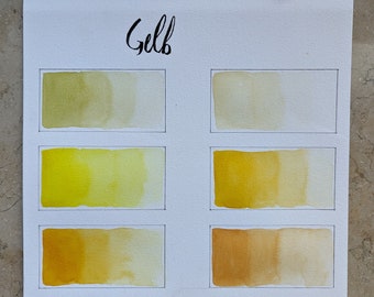 Handgemachte Aquarellfarbe Gelb und Orangetöne in Halbepfännchen, Pods und Paletten