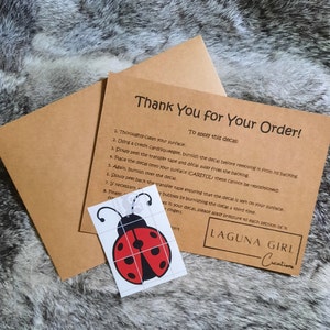 Normal Red and Black Vinyl Lady Bug Decal. Comes with transfer tape already applied and an instruction card