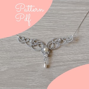 May include: A silver-colored tatting lace necklace featuring a central white pearl, smaller accent pearls, and a teardrop-shaped pearl pendant. The design includes intricate looped thread work and the text Pattern Pdf in the upper left corner.
