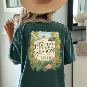 May include: A teal blue t-shirt with a floral design and the text "For everything there is a season and a time for every purpose under heaven, Ecclesiastes 3".