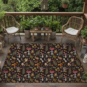 May include: A dark brown outdoor rug with a whimsical forest pattern featuring mushrooms, ferns, and dragonflies. The rug is placed on a patio with wicker chairs, plants, and lanterns, creating a cozy outdoor space.