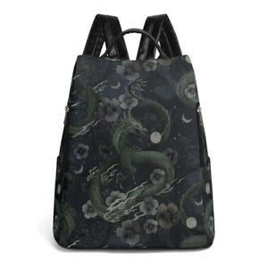 May include: Black backpack with a green and white dragon and floral pattern.