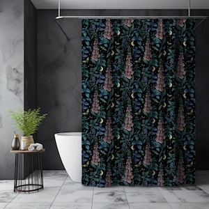 May include: A black shower curtain with a floral pattern featuring pink and blue foxglove flowers, green leaves, and crescent moons.