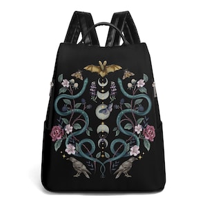 May include: Black leather backpack with a detailed design featuring intertwined snakes, flowers, a bat, and a crescent moon. The design is in shades of green, purple, and gold.