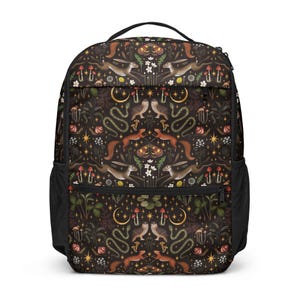 May include: Black backpack featuring a repeating pattern of woodland animals, such as rabbits, squirrels, and owls, alongside mushrooms, crescent moons, and stars. The bag has a top handle, a front pocket, and side mesh pockets.