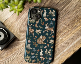 May include: A dark blue phone case with a whimsical woodland pattern. The design features a variety of animals, including deer, rabbits, bears, and raccoons, along with mushrooms, flowers, and berries.