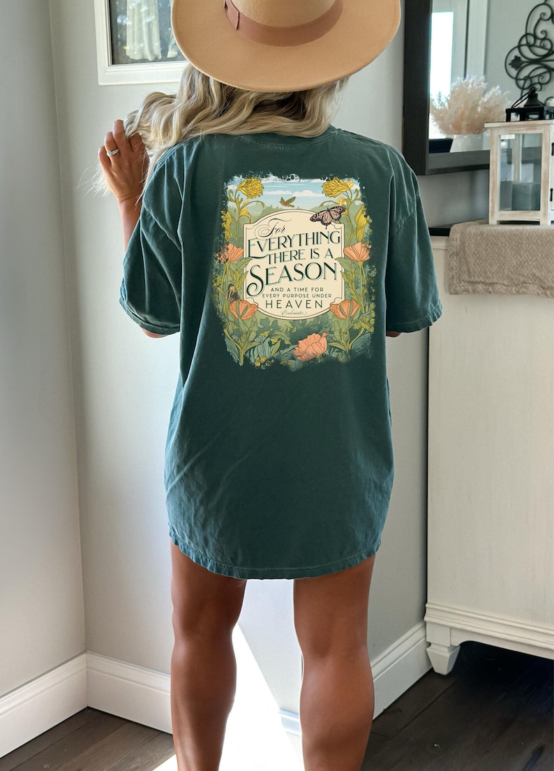 May include: A teal blue t-shirt with a floral design and the text "For everything there is a season and a time for every purpose under heaven, Ecclesiastes 3".
