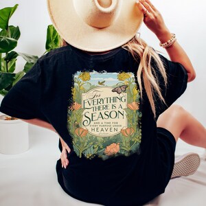 May include: Black t-shirt with a floral design and the text "For everything there is a season and a time for every purpose under heaven."  The design features a butterfly and a vintage-style font.