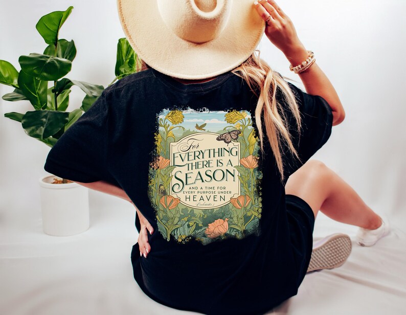 May include: Black t-shirt with a floral design and the text "For everything there is a season and a time for every purpose under heaven."  The design features a butterfly and a vintage-style font.