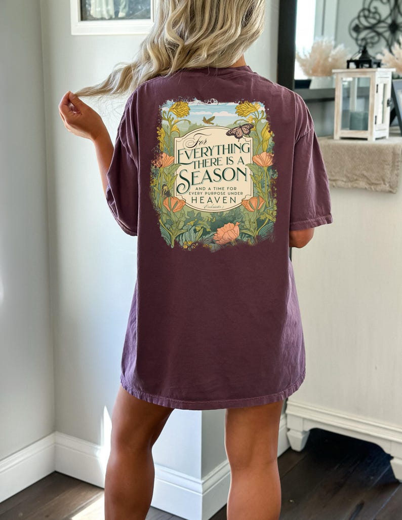May include: A purple t-shirt with a floral design and the text "For everything there is a season and a time for every purpose under heaven".
