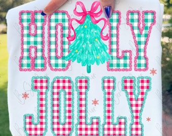 May include: White sweatshirt with the words "HOLLY JOLLY" in a plaid pattern. A teal Christmas tree with a pink bow is in the center. The letters are outlined in a contrasting color, and snowflakes are scattered around the text.