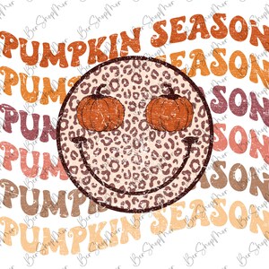 May include: A smiling leopard print face with two pumpkins for eyes. The text "Pumpkin Season" is repeated in a vintage style font in various shades of orange, pink, and brown.