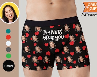 May include: Black boxer shorts with a red heart and face pattern. The text "I'm NUTS about you" is printed in white on the front.